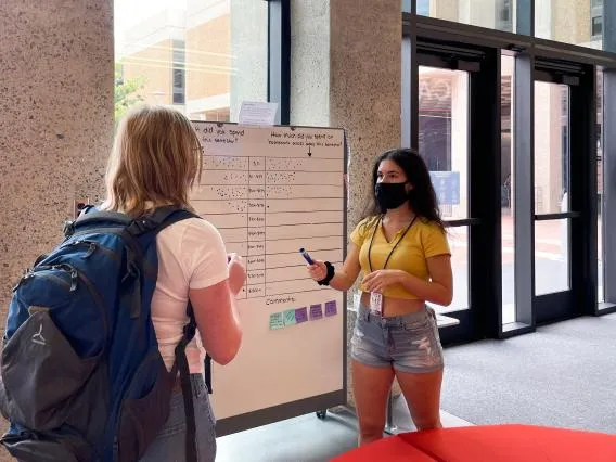 Two women meet in a building