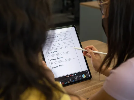 Two students prototyping on an iPad